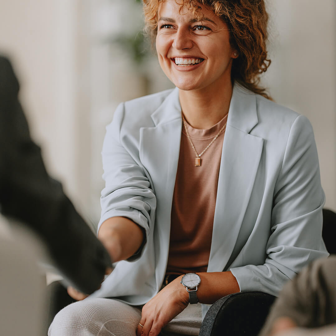 Smiling woman shaking hands during an interview – careers at NutraPet built on respect, autonomy and short paths